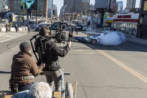 Formula E, Car does stunt while crew record with advanced gear