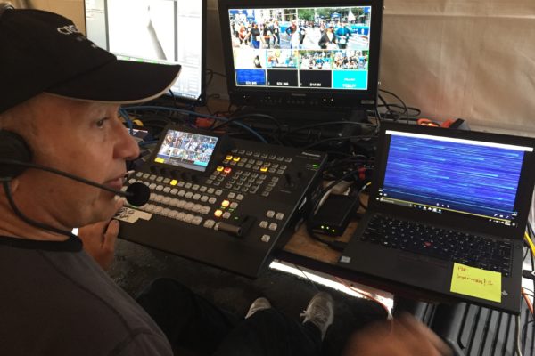 A man in a video booth running equipment