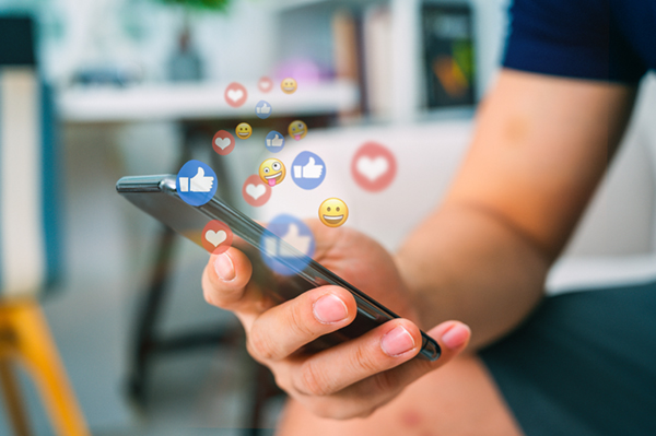 Hand using smart phone with Social media concept Social media reactions
