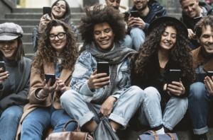 Gen Z social media influencers and fans sitting on stairs wasting their lives while smiling. 