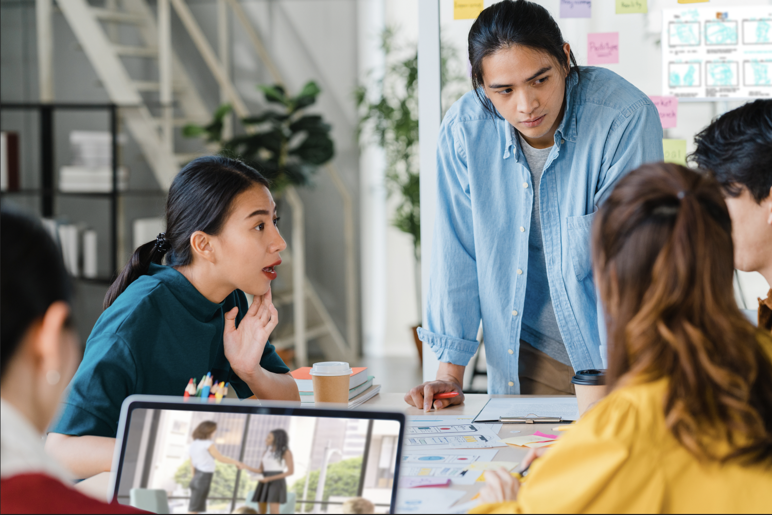 Design team around a table discussing design elements