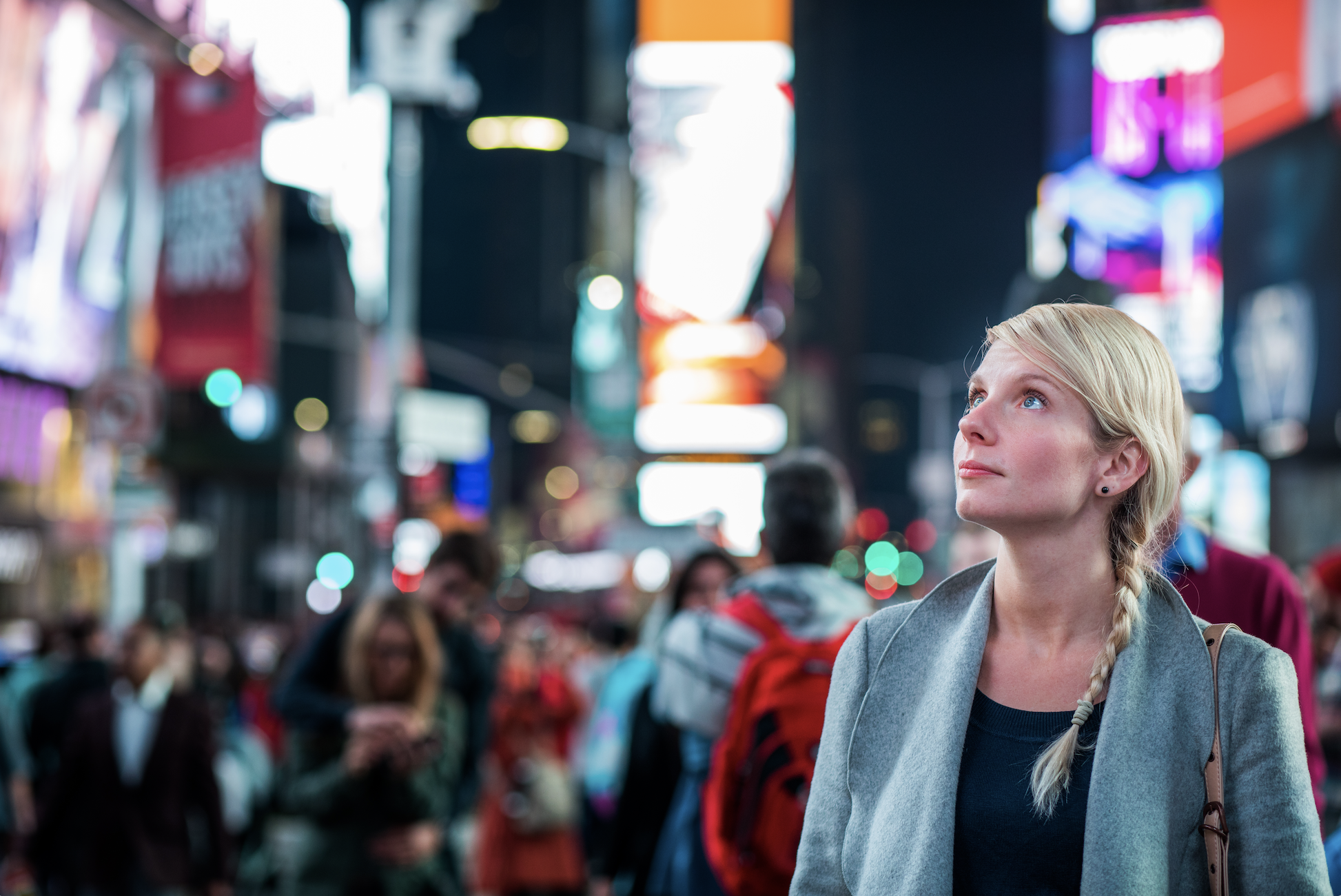 Times square video production, woman watches video billboards