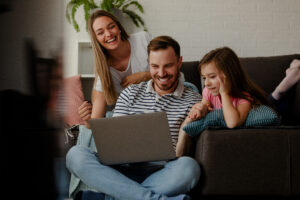Family gathers to watch video on computer