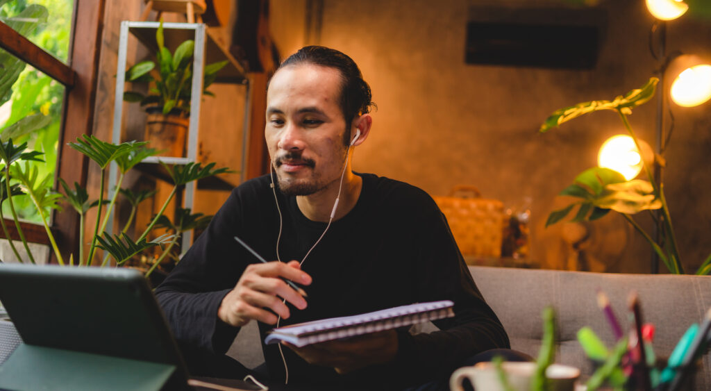 Asian Man listening to a podcast about enlightenment