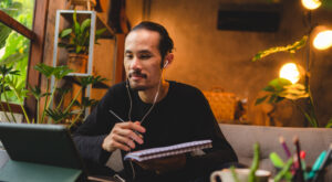 Asian Man listening to a podcast about enlightenment